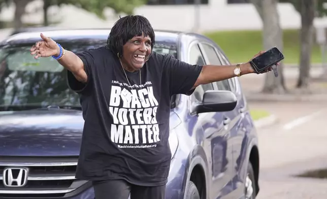 Jaqquelyn Germany reaches out for a hug as students march and dance to a campus polling place on Election Day at Southern University in Baton Rouge, La., Tuesday, Nov. 5, 2024. (AP Photo/Gerald Herbert)