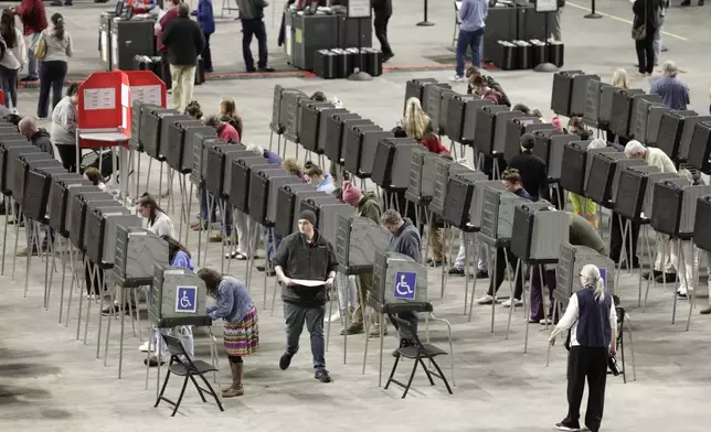 Voters fill out their ballots on Election Day Tuesday, Nov. 5, 2024, at the Cross Insurance Center in Bangor, Maine. (AP Photo/Joel Page)