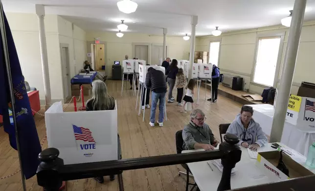 People cast their votes on Election Day, Tuesday, Nov. 5, 2024 in Pownal, Maine. (AP Photo/Joel Page)