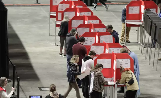 Voters fill out their ballots on Election Day Tuesday, Nov. 5, 2024 at the Cross Insurance Center in Bangor, Maine. (AP Photo/Joel Page)