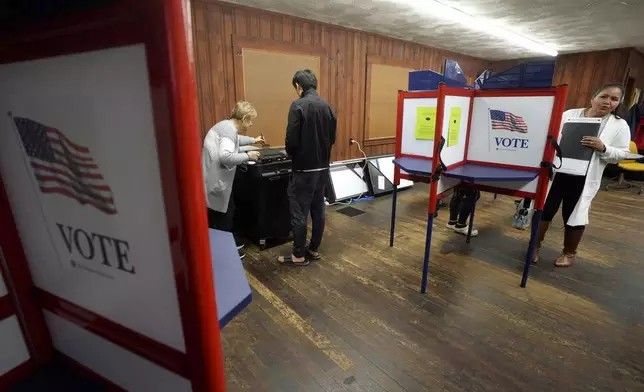 Voters cast their ballots at a polling place, Tuesday, Nov. 5, 2024, in Waltham, Mass. (AP Photo/Steven Senne)