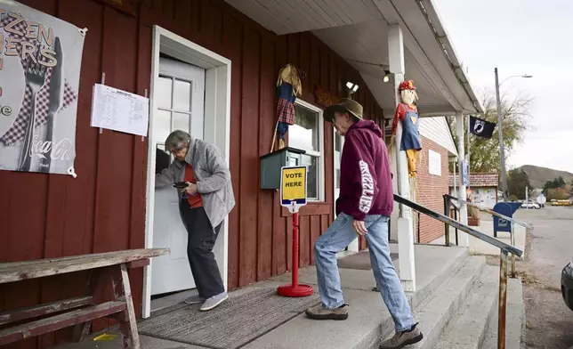 Charles and Pearl Cunningham walk into Drummond Community Hall to vote in Drummond, Mont., on Election Day, Tuesday, Nov. 5, 2024. (AP Photo/Tommy Martino)