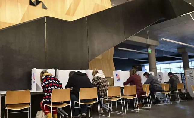 Missoulians vote at the Missoula Public Library in Missoula, Mont., on Election Day, Tuesday, Nov. 5, 2024. (AP Photo/Tommy Martino)