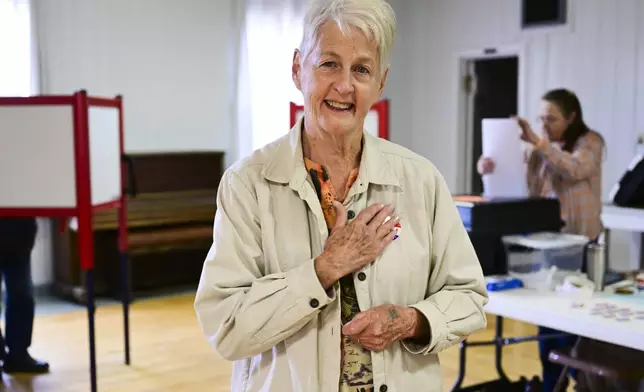 Karen DesRosier places an "I Voted" sticker on her chest after casting a ballot at the Drummond Community Hall in Drummond, Mont., on Election Day, Tuesday, Nov. 5, 2024. (AP Photo/Tommy Martino)