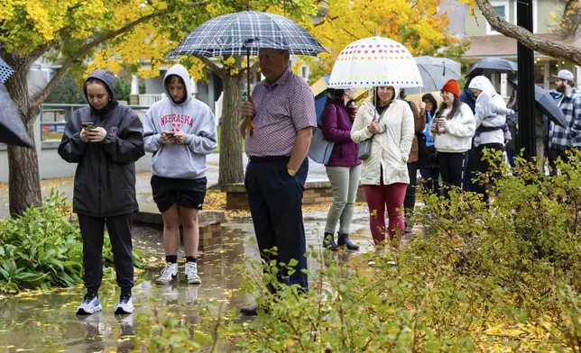 Voters line up to cast their ballots at Dundee Elementary School in Omaha, Neb., on Election Day, Tuesday, Nov. 5, 2024. (AP Photo/Bonnie Ryan)