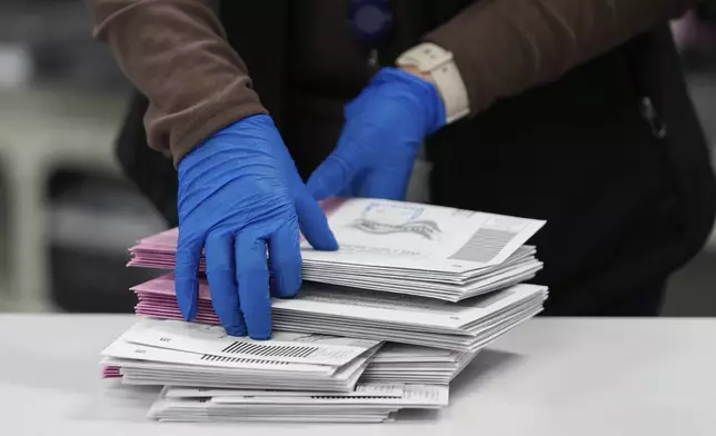 An Election worker sorts mail-in ballots at the Washoe County Registrar of Voters office, Tuesday, Nov. 5, 2024, in Reno, Nev. (AP Photo/Godofredo A. Vásquez)