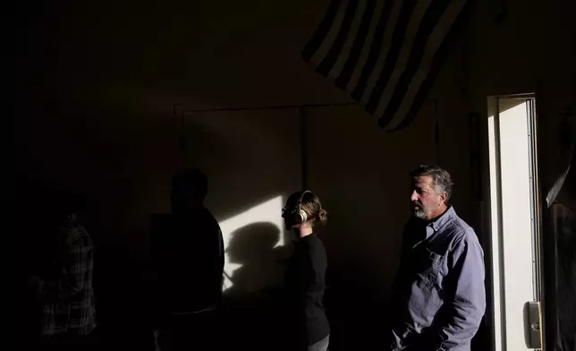 People wait in line to vote at South Valleys Library, Tuesday, Nov. 5, 2024, in Reno, Nev. (AP Photo/Godofredo A. Vasquez)