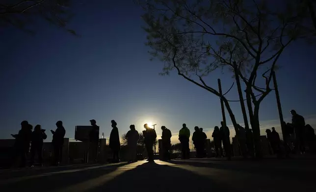 People line up to vote outside Allegiant Stadium, Tuesday, Nov. 5, 2024, in Las Vegas. (AP Photo/John Locher)