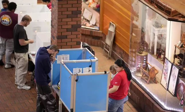 People vote at the Reno Town Mall, Tuesday, Nov. 5, 2024, in Reno, Nev. (AP Photo/Godofredo A. Vasquez)