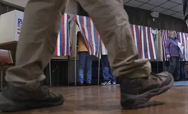 People cast their ballots at a polling place at VFW Post 2520, on Election Day, Tuesday, Nov. 5, 2024, in Berlin, N.H. (AP Photo/Charles Krupa)