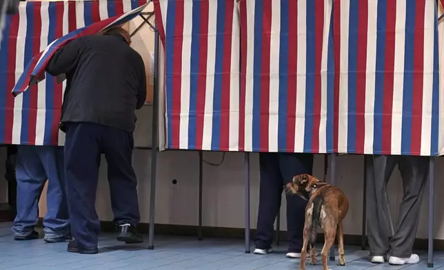 People cast their ballots at a polling place at VFW Post 2520, on Election Day, Tuesday, Nov. 5, 2024, in Berlin, N.H. (AP Photo/Charles Krupa)