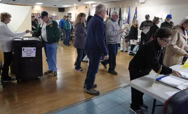 People wait in line to cast their ballots at a polling place at VFW Post 2520, on Election Day, Tuesday, Nov. 5, 2024, in Berlin, N.H. (AP Photo/Charles Krupa)