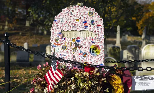 The headstone of Susan B. Anthony is covered in "I voted" stickers at Mount Hope Cemetery in Rochester, New York on Election Day, Tuesday, Nov. 5, 2024. (AP Photo/Lauren Petracca)