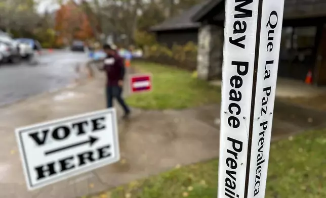 A voter leaves a polling place at St. James Episcopal Church in Black Mountain, N.C. on Tuesday, Nov. 5, 2024. The town near Asheville was among the many hard hit by Hurricane Helene, and the church was hosting two displaced precincts. (AP Photo/Allen G. Breed)