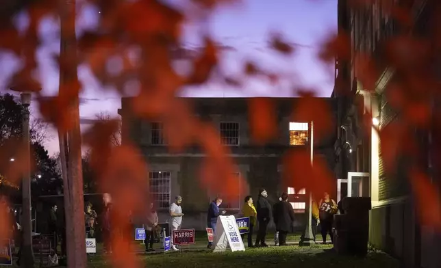 Voters wait in line to cast their ballots at the Kingston Armory in Wilkes-Barre, Pa, Tuesday, Nov. 5, 2024. (AP Photo/Matt Rourke)