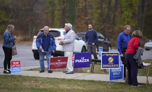 People arrive at polling place to vote, Tuesday, Nov. 5, 2024, in Springfield, Pa. (AP Photo/Matt Slocum)