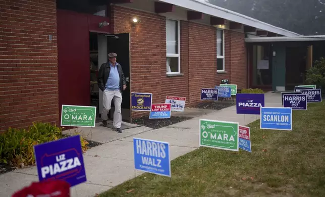 A man departs a polling place, Tuesday, Nov. 5, 2024, in Springfield, Pa. (AP Photo/Matt Slocum)