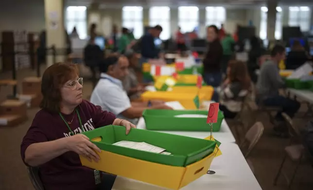 Election workers process mail-in ballots for the 2024 General Election at the Chester County, Pa., administrative offices, Tuesday, Nov. 5, 2024, in West Chester, Pa. (AP Photo/Matt Slocum)