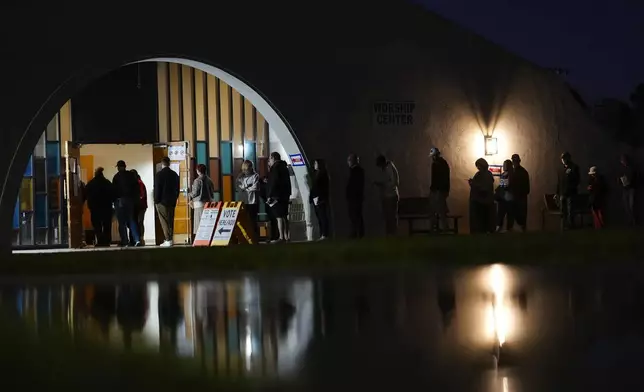 Voters stand in line outside a polling place at Madison Church, Tuesday, Nov. 5, 2024, in Phoenix, Ariz. (AP Photo/Matt York)