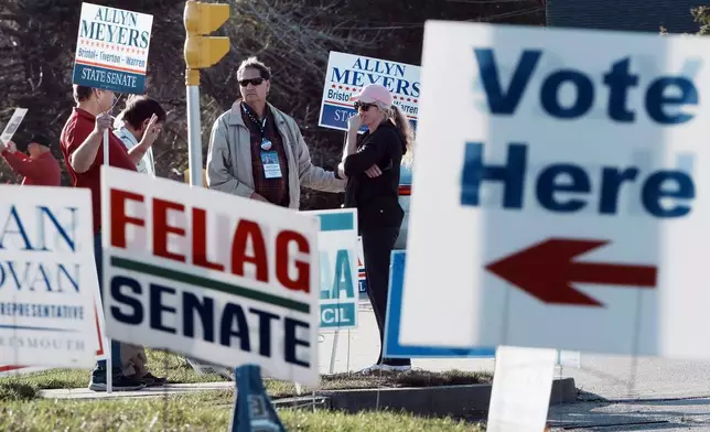 People show their support for state Senate candidate Allyn Meyers outside a polling place on Election Day, Tuesday, Nov. 5, 2024, in Bristol, R.I. (AP Photo/Michael Dwyer)