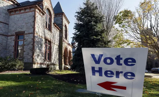 A "Vote Here" sign indicates the polling place at the Town Hall on Election Day, Tuesday, Nov. 5, 2024, in Bristol, R.I. (AP Photo/Michael Dwyer)