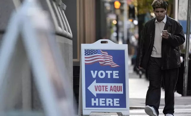 A man walks past the polling place at City Hall in Providence R.I., Tuesday, Nov. 5, 2024. (AP Photo/Michael Dwyer)