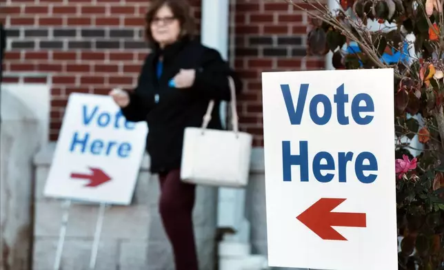 A woman leaves a polling place on Election Day, Tuesday, Nov. 5, 2024, in Bristol, R.I. (AP Photo/Michael Dwyer)