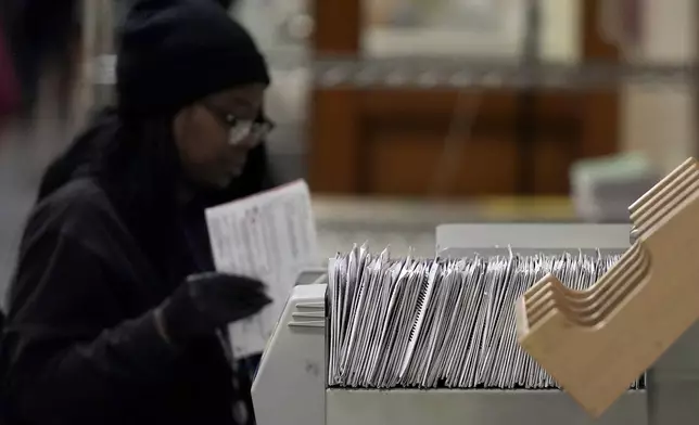 A Department of Elections worker sorts ballots at City Hall in San Francisco, Monday, Nov. 4, 2024. (AP Photo/Jeff Chiu)