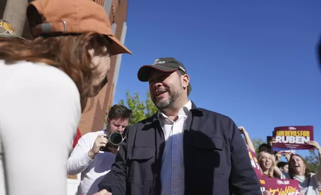 Arizona Democratic Senate candidate Rep. Ruben Gallego, D-Ariz., meets with voters at Arizona State University on Election Day Tuesday, Nov. 5, 2024, in Tempe, Ariz. (AP Photo/Ross D. Franklin)