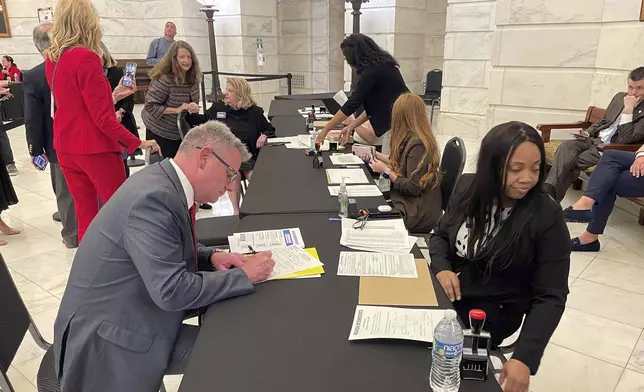 FILE - Marcus Jones, front left, files paperwork to run for Arkansas' 2nd Congressional District at the state Capitol in Little Rock, Ark., Nov. 6, 2023. (AP Photo/Andrew DeMillo, File)