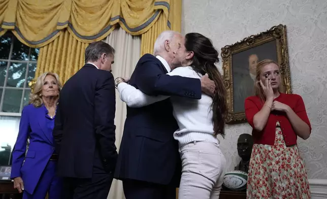 President Joe Biden hugs Ashley Biden after addressing the nation from the Oval Office of the White House in Washington, Wednesday, July 24, 2024, about his decision to drop his Democratic presidential reelection bid. Also watching are first lady Jill Biden, Hunter Biden and Finnegan Biden, right. (AP Photo/Evan Vucci, Pool)