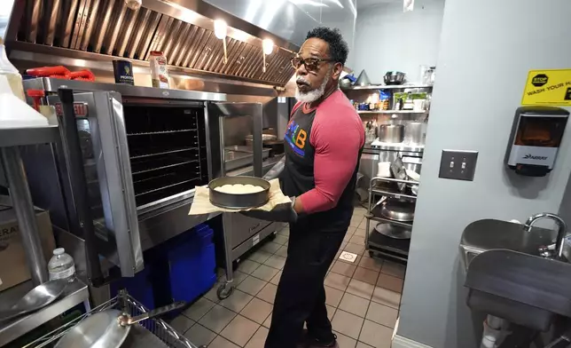 Small business owner Michael Hooks works in the kitchen of his catering business in Erie, Pa. Friday, Nov. 1, 2024. (AP Photo/Gene J. Puskar)