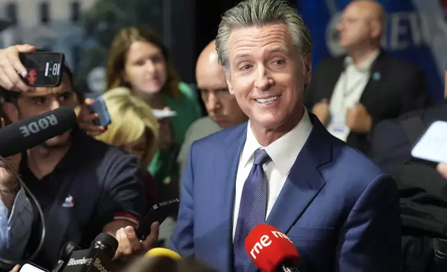 FILE - California Gov. Gavin Newsom speaks to reporters in the spin room before a presidential debate between Republican presidential nominee former President Donald Trump and Democratic presidential nominee Vice President Kamala Harris, Tuesday, Sept. 10, 2024, in Philadelphia. (AP Photo/Matt Rourke)