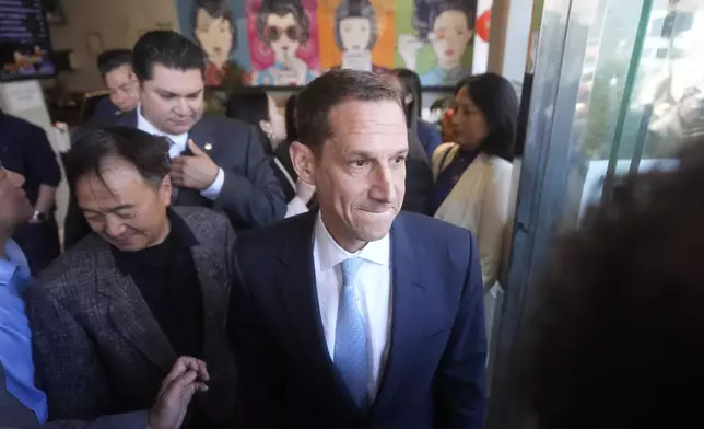 San Francisco mayoral candidate Daniel Lurie tours businesses as he walks through Chinatown in San Francisco, Friday, Nov. 8, 2024. (AP Photo/Jeff Chiu)