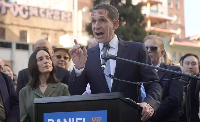 Daniel Lurie speaks at a news conference accompanied by his wife, Becca Prowda, left, in San Francisco, Friday, Nov. 8, 2024. (AP Photo/Jeff Chiu)