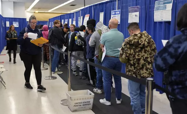 People line up to vote at the Chicago Early Voting Loop Supersite in Chicago, Thursday, Oct. 24, 2024. (AP Photo/Nam Y. Huh)