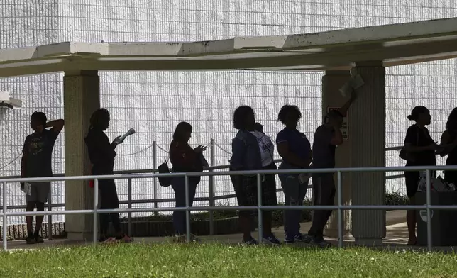 Miami-Dade residents wait in line to vote at the Joseph Caleb Center during the "Souls to the Polls" event on the last day of early voting Sunday, Nov. 3, 2024, in Miami. (Carl Juste/Miami Herald via AP)