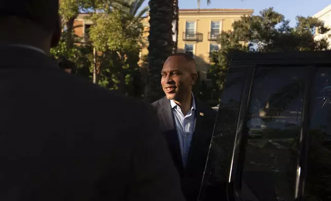 House Minority Leader Hakeem Jeffries, D-N.Y., center, departs following an interview with The Associated Press, Saturday, Oct. 12, 2024, in Irvine, Calif. (AP Photo/Julia Demaree Nikhinson)