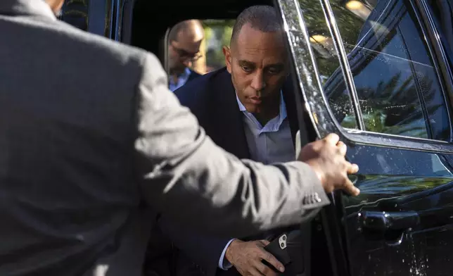 House Minority Leader Hakeem Jeffries, D-N.Y., center, arrives for an interview with The Associated Press, Saturday, Oct. 12, 2024, in Irvine, Calif. (AP Photo/Julia Demaree Nikhinson)