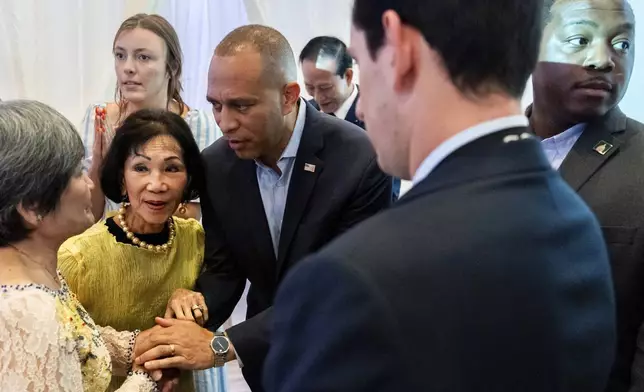 House Minority Leader Hakeem Jeffries, D-N.Y., center, speaks with attendees during a campaign event for Derek Tran at Golden Sea Restaurant, Saturday, Oct. 12, 2024, in Anaheim, Calif. (AP Photo/Julia Demaree Nikhinson)