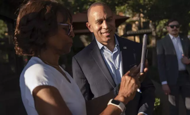 House Minority Leader Hakeem Jeffries, D-N.Y., center, takes a selfie with a supporter, Saturday, Oct. 12, 2024, in Irvine, Calif. (AP Photo/Julia Demaree Nikhinson)