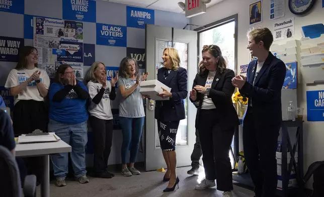 First lady Jill Biden, center, delivers boxes of cookies to supporters at an election event for Democratic presidential nominee Vice President Kamala Harris, Monday, Nov. 4, 2024, in Carrboro, N.C. (AP Photo/Grant Halverson)