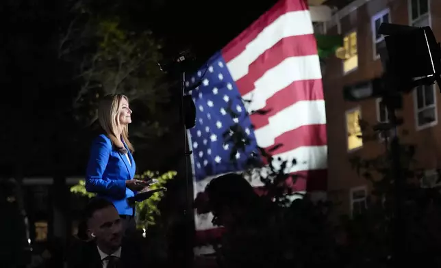 Members of the media work ahead of an election night campaign watch party for Democratic presidential nominee Vice President Kamala Harris, Tuesday, Nov. 5, 2024, on the campus of Howard University in Washington. (AP Photo/Ben Curtis)