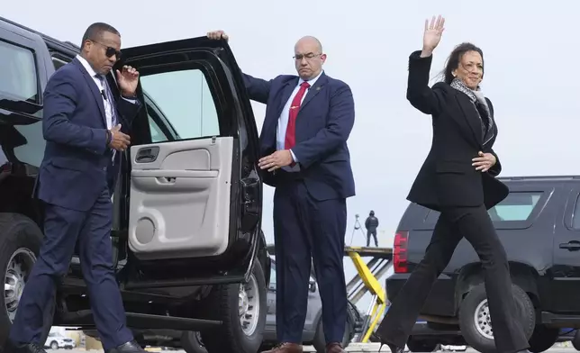 Democratic presidential nominee Vice President Kamala Harris waves as she walks to board Air Force Two at Detroit Metropolitan Wayne County Airport in Detroit, Monday Nov. 4, 2024, en route to Pennsylvania. (AP Photo/Jacquelyn Martin, Pool)