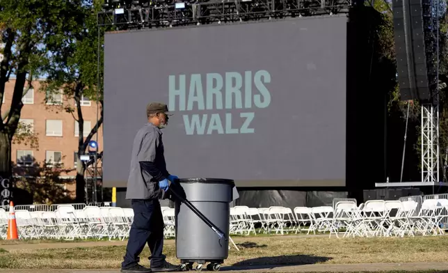 Eric Brown picks up trash left behind from Democratic presidential nominee Vice President Kamala Harris' election night campaign watch party Wednesday, Nov. 6, 2024, on the campus of Howard University in Washington. (AP Photo/David J. Phillip)