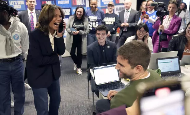 Democratic presidential nominee Vice President Kamala Harris, left, reacts as she phone banks with volunteers at the DNC headquarters on Election Day, Tuesday, Nov. 5, 2024, in Washington. (AP Photo/Jacquelyn Martin)