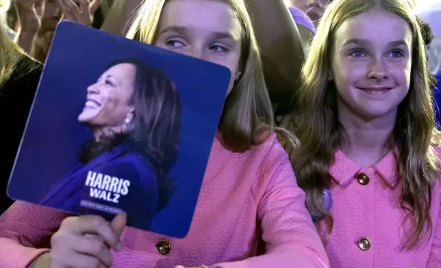 Young supporters listen as Democratic presidential nominee Vice President Kamala Harris speaks during a campaign rally, Saturday, Nov. 2, 2024, at the PNC Music Pavilion in Charlotte, N.C. (AP Photo/Jacquelyn Martin)