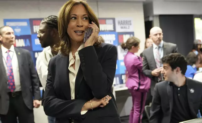 Democratic presidential nominee Vice President Kamala Harris phone banks with volunteers at the DNC headquarters on Election Day, Tuesday, Nov. 5, 2024, in Washington. (AP Photo/Jacquelyn Martin)