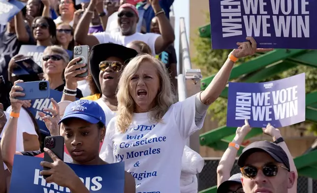 Supporters listen as Democratic presidential nominee Vice President Kamala Harris speaks during a campaign rally outside the Atlanta Civic Center, Saturday, Nov. 2, 2024. (AP Photo/Jacquelyn Martin)