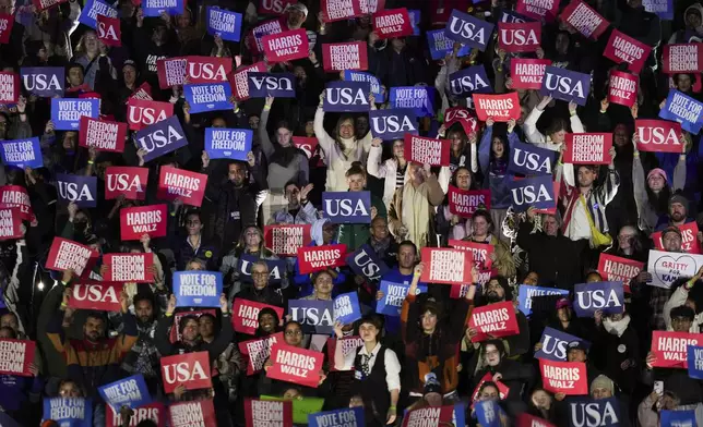 Supporters hold signs during a campaign rally supporting Democratic presidential nominee Vice President Kamala Harris outside the Philadelphia Museum of Art, Monday, Nov. 4, 2024, in Philadelphia. (AP Photo/Matt Slocum)